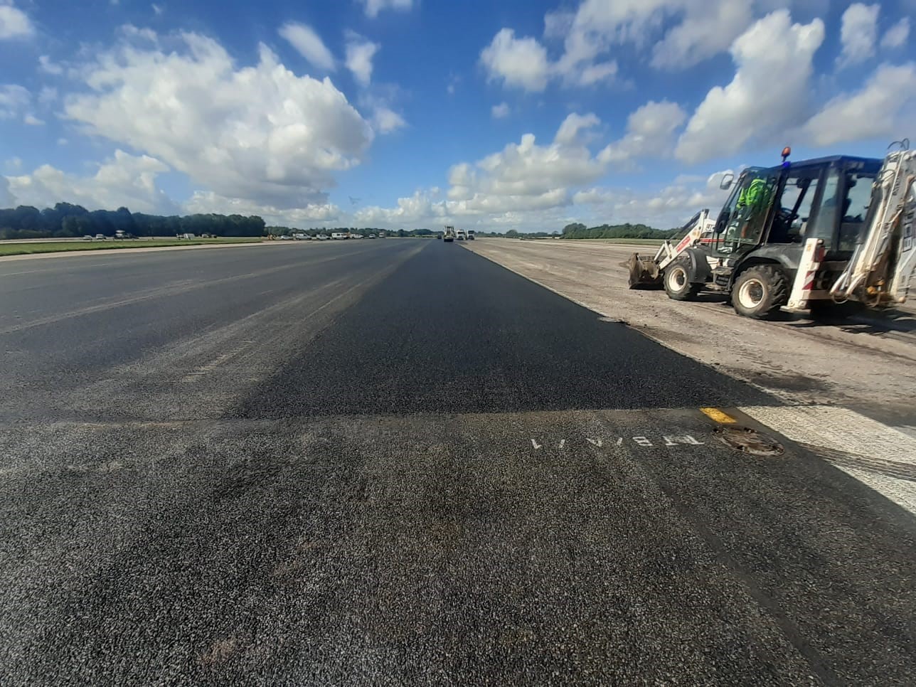 Photo - Vehicles and operators carrying out maintenance to the runway at RAF Brize Norton